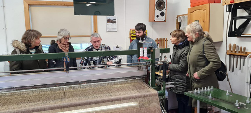 Students with a harris tweed weaver Students with a harris tweed weaver