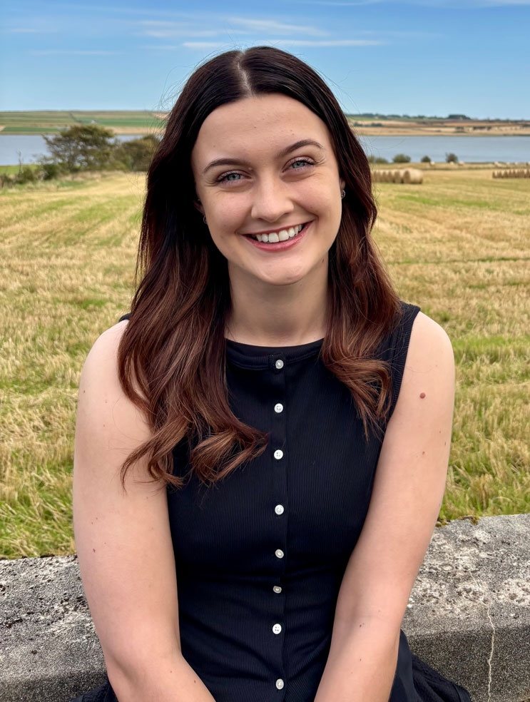 a student sitting and smiling