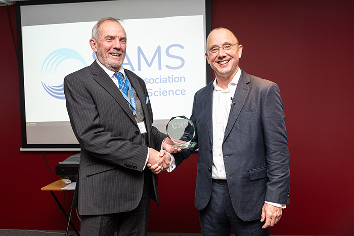 Professor Nick Owens, Director of SAMS, handing Adam Hughes, Professor of Innovation in the Blue Economy, a glass award. Photo credit: SAMS and UHI