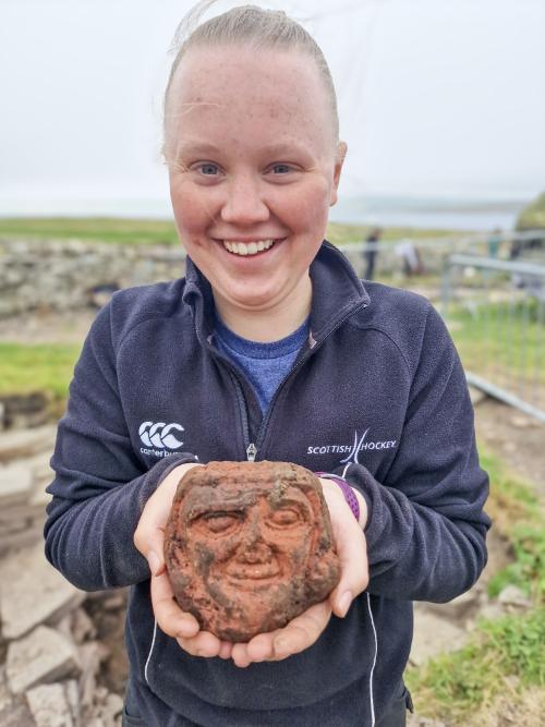 UHI Archaeology Institute undergraduate student Katie Joss with the Skaill carved head