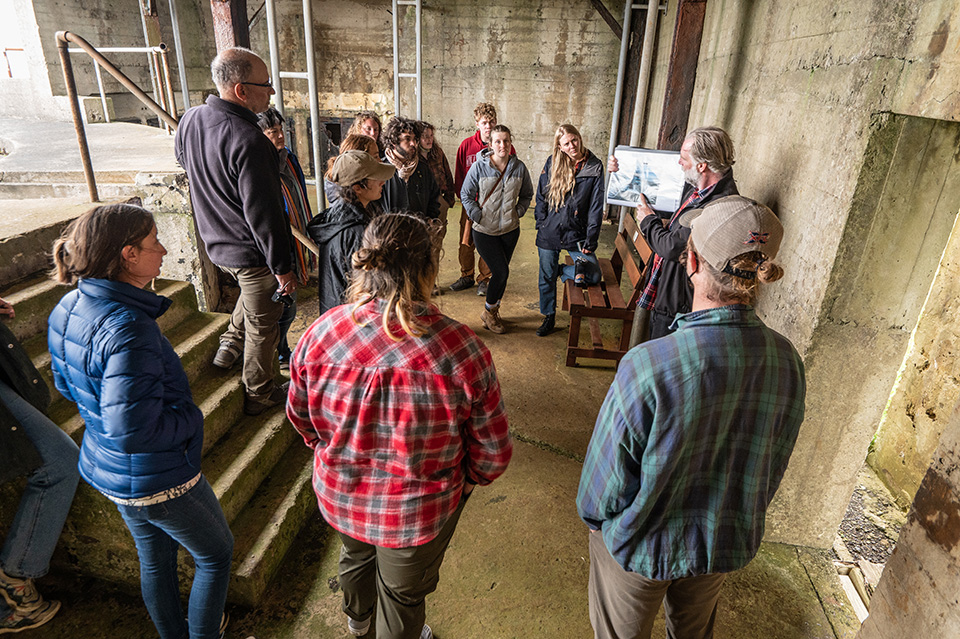 Group of people listening to a speaker at an archaeology site Group of people listening to a speaker at an archaeology site