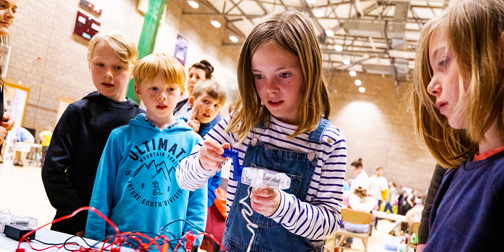 Students engaging with a science experiment. Students engaging with a science experiment.