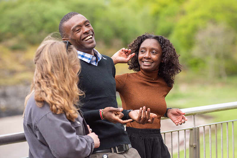 Three people laughing and smiling Three people laughing and smiling
